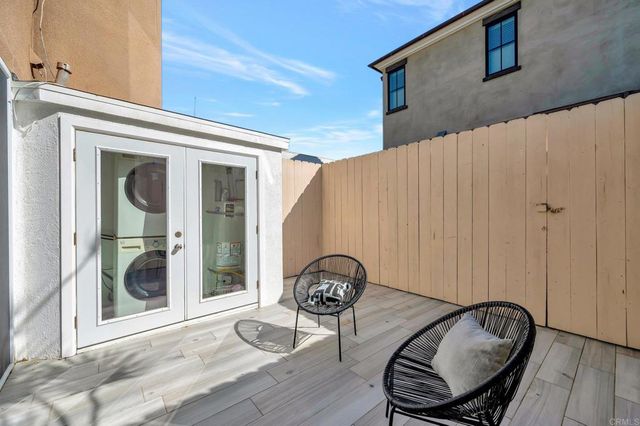 a view of a porch with furniture and a yard
