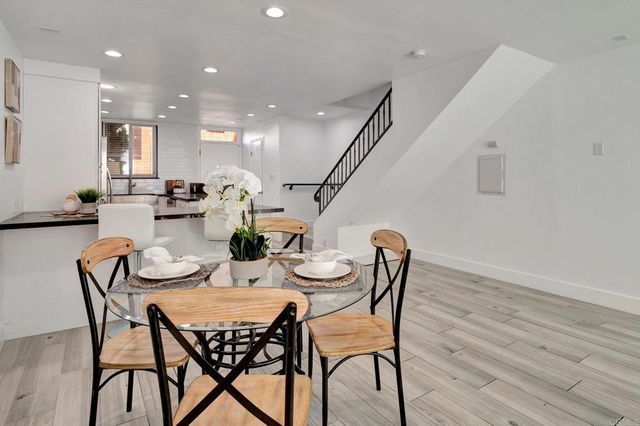 a view of a hallway with wooden floor and windows