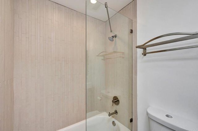 a view of a car is parked on the side of a street