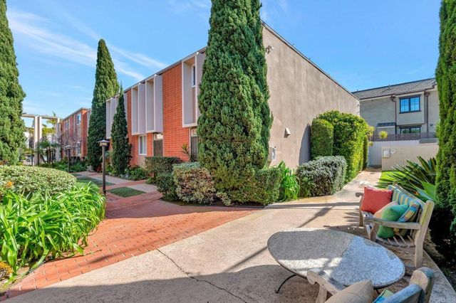 a backyard of a house with table and chairs