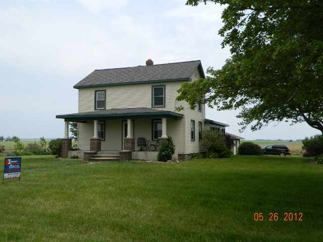 10489 Maple Grove Road Lanark, IL 61046 - Photo 1 of 2 a house that is sitting in the grass
