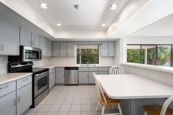 a kitchen with a sink cabinets and window