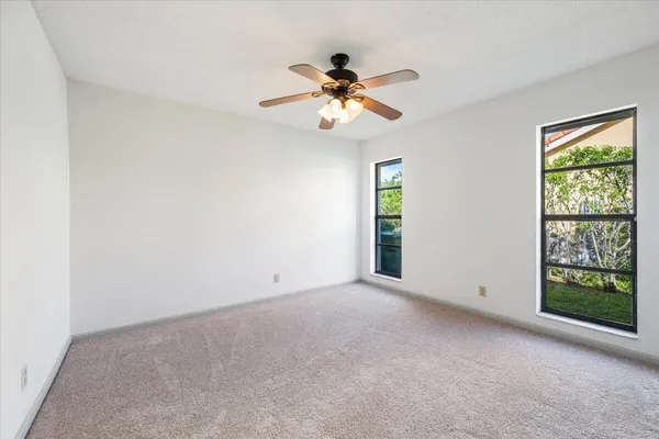 an empty room with windows and closet