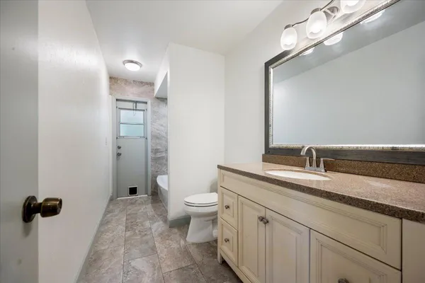 an empty room with chandelier fan