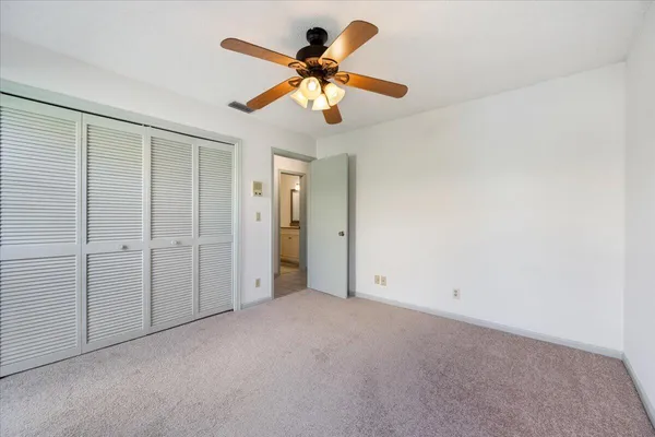 an empty room with fan and entrance