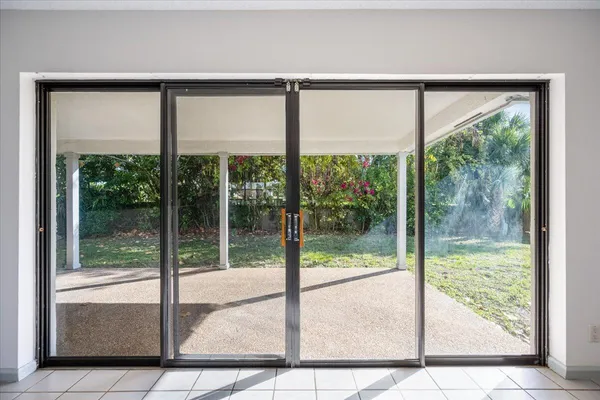 a view of kitchen with furniture and refrigerator