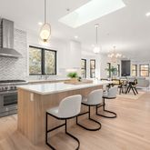 a large kitchen with lots of counter space dining table and chairs