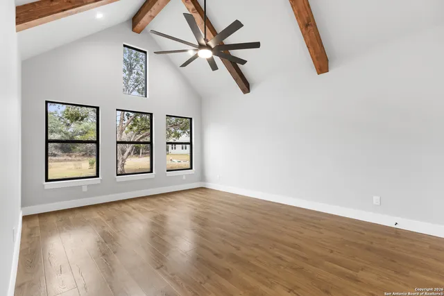 wooden floor in an empty room with a window