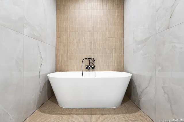 a white bath tub sitting in a bathroom