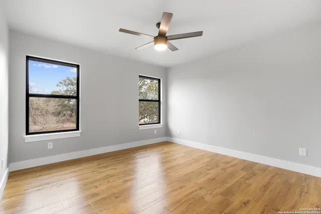 wooden floor in an empty room with a window