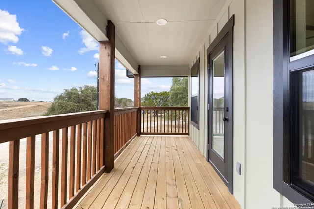 a view of a balcony with wooden floor
