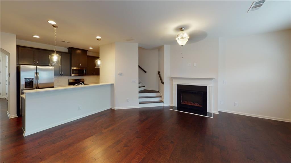 a view of a kitchen with a sink and a fireplace