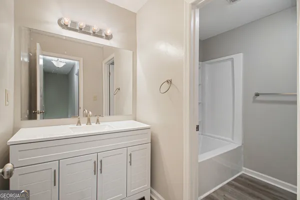 a bathroom with a sink a mirror and a shower