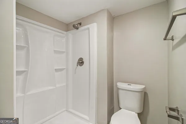 a bathroom with a toilet and shower