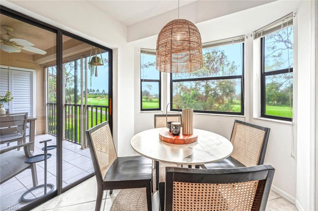 7300 St Ives Way, Unit 5208 Naples, FL 34104 - Photo 11 of 37 a view of a dining room with furniture window and outside view