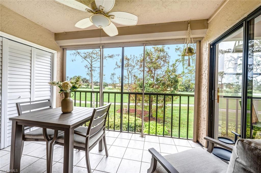 7300 St Ives Way, Unit 5208 Naples, FL 34104 - Photo 25 of 37 a view of a dining room with furniture window and outside view