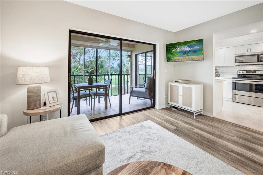 7300 St Ives Way, Unit 5208 Naples, FL 34104 - Photo 6 of 37 a spacious bedroom with a large bed and a large window