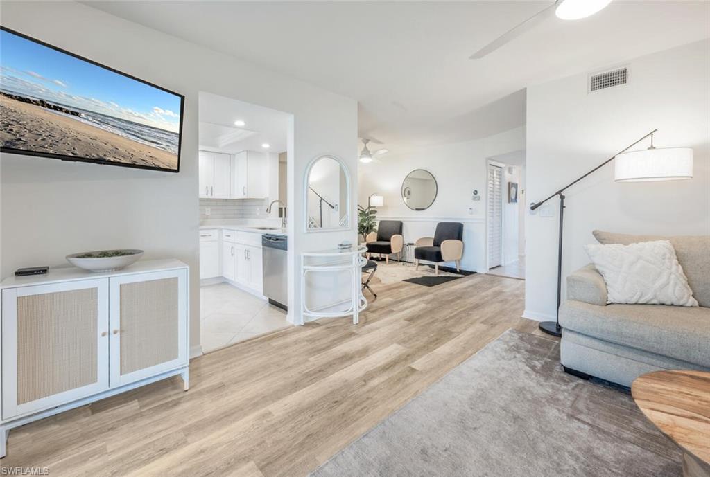 7300 St Ives Way, Unit 5208 Naples, FL 34104 - Photo 7 of 37 a living room with furniture and a wooden floor