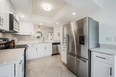a kitchen with a sink stove and microwave
