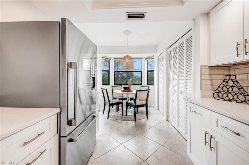 7300 St Ives Way, Unit 5208 Naples, FL 34104 - Photo 10 of 37 a dining room with furniture and a large window