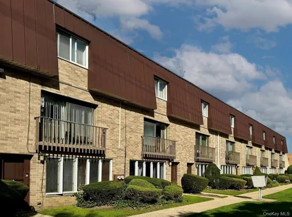 a front view of a building with a garden