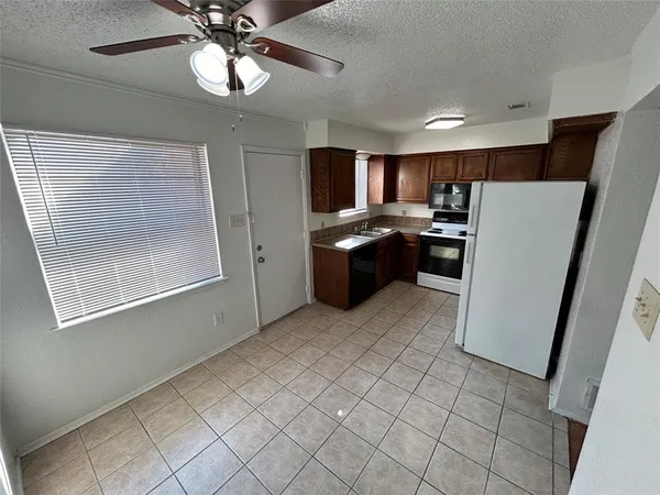 a kitchen with a refrigerator a stove top oven a sink and dishwasher