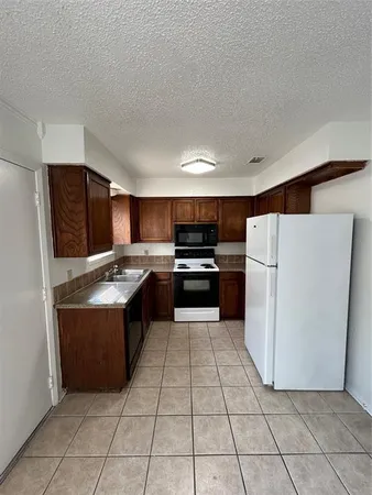a large kitchen with a stove top oven and cabinets