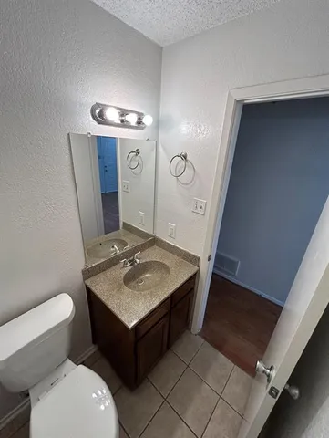 a bathroom with a sink a toilet and mirror
