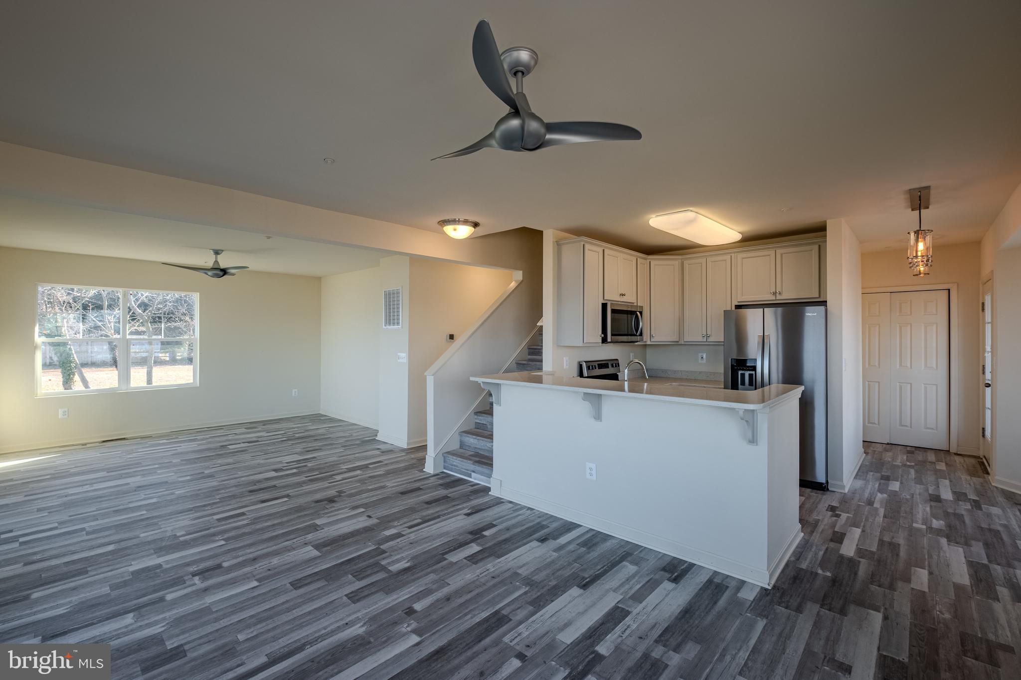 7391 Benedict Avenue Benedict, MD 20612 - Photo 14 of 38 a view of kitchen and empty room with wooden floor