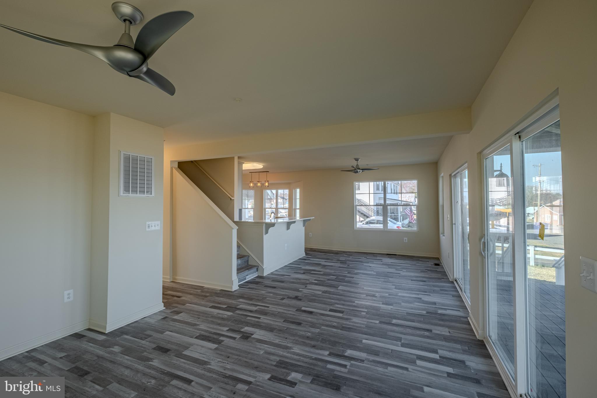 7391 Benedict Avenue Benedict, MD 20612 - Photo 15 of 38 a view of an empty room with glass door and wooden floor