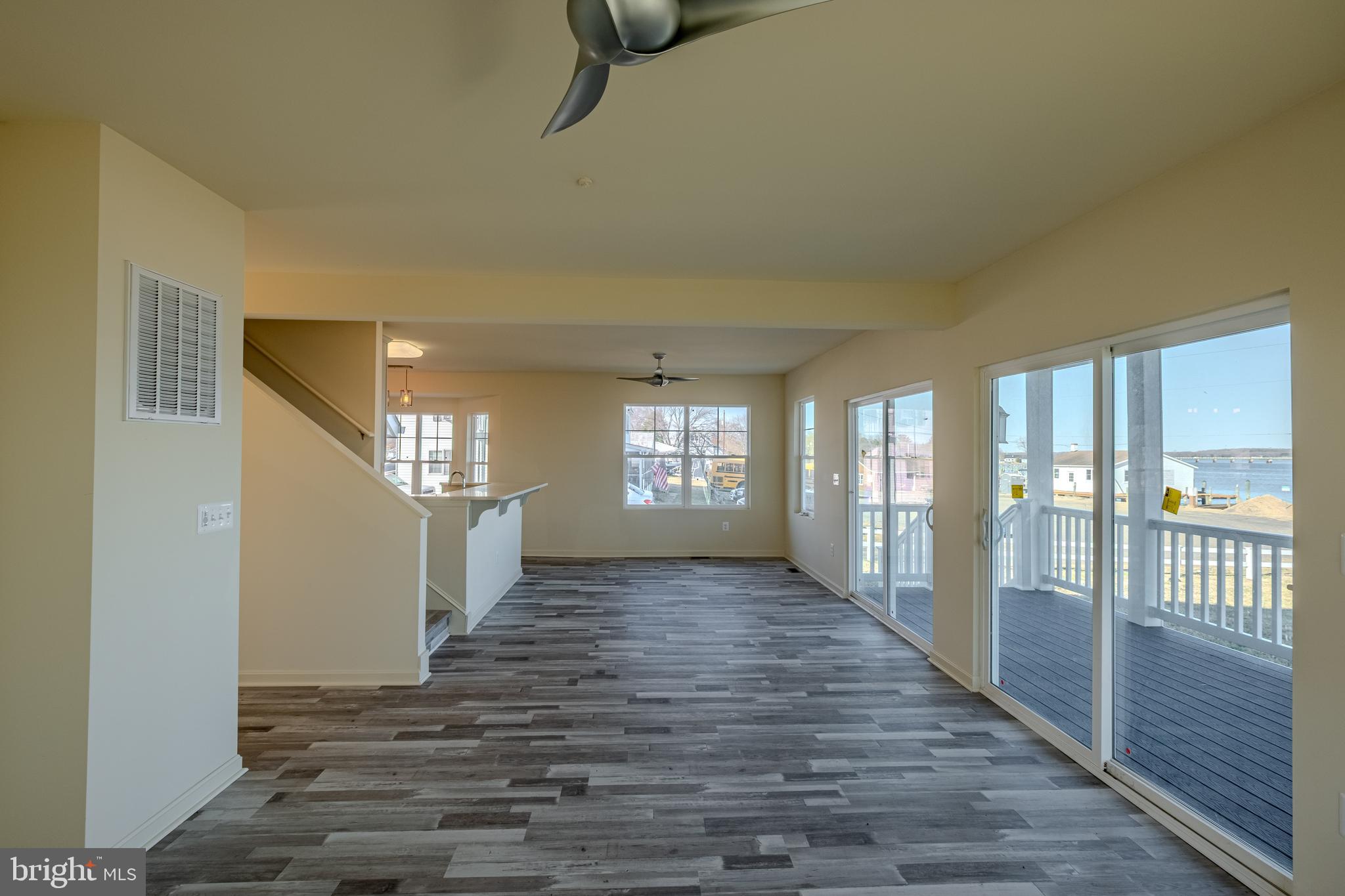 7391 Benedict Avenue Benedict, MD 20612 - Photo 16 of 38 a view of a hallway with wooden floor and windows