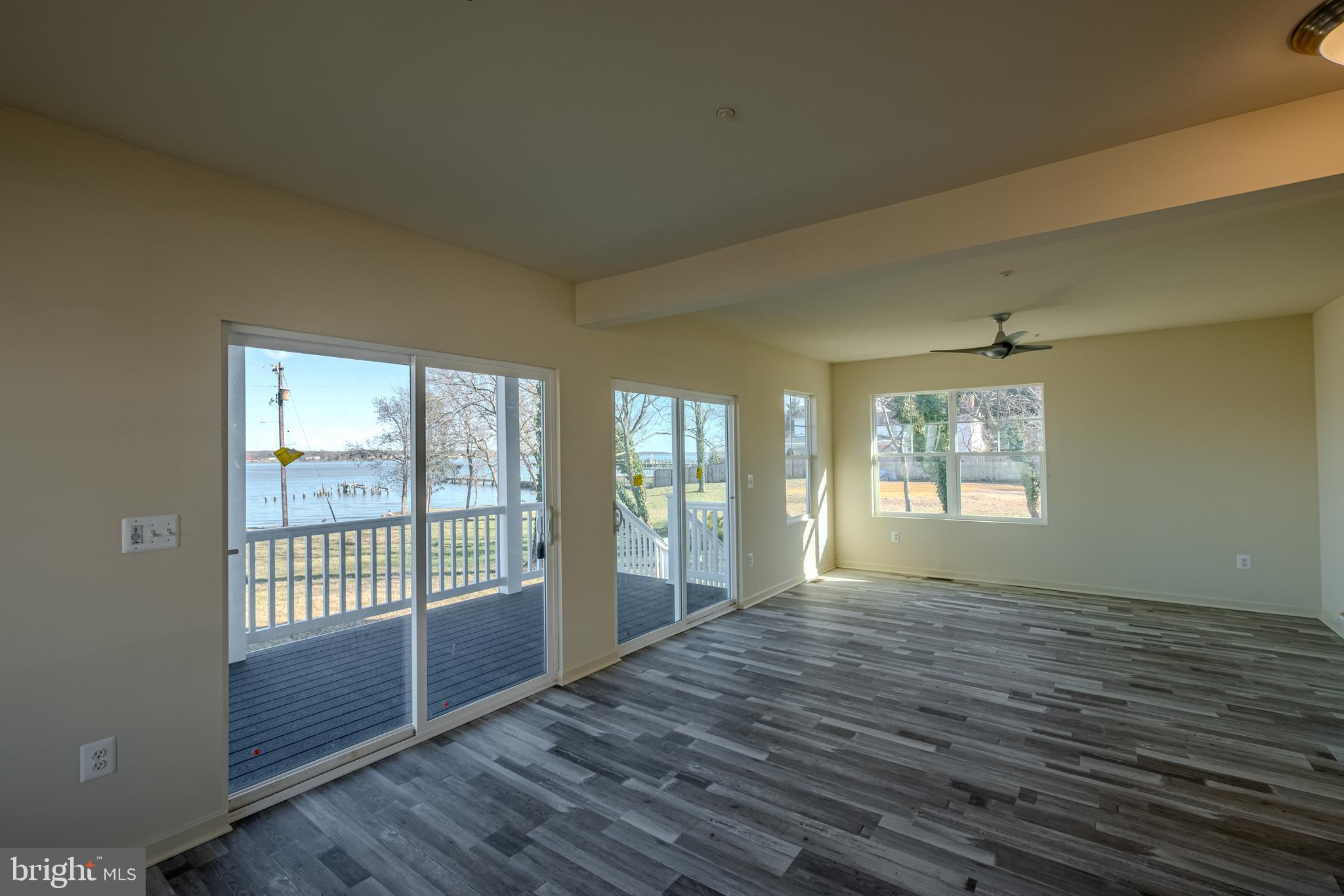 7391 Benedict Avenue Benedict, MD 20612 - Photo 17 of 38 a view of an empty room with wooden floor and a window