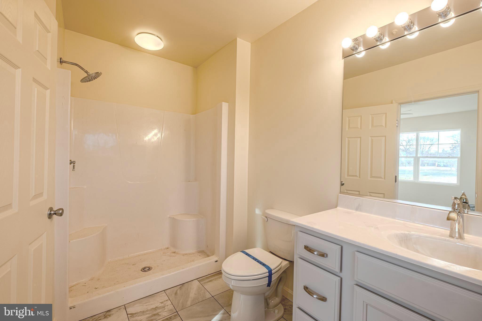 7391 Benedict Avenue Benedict, MD 20612 - Photo 20 of 38 a bathroom with a sink a toilet and shower