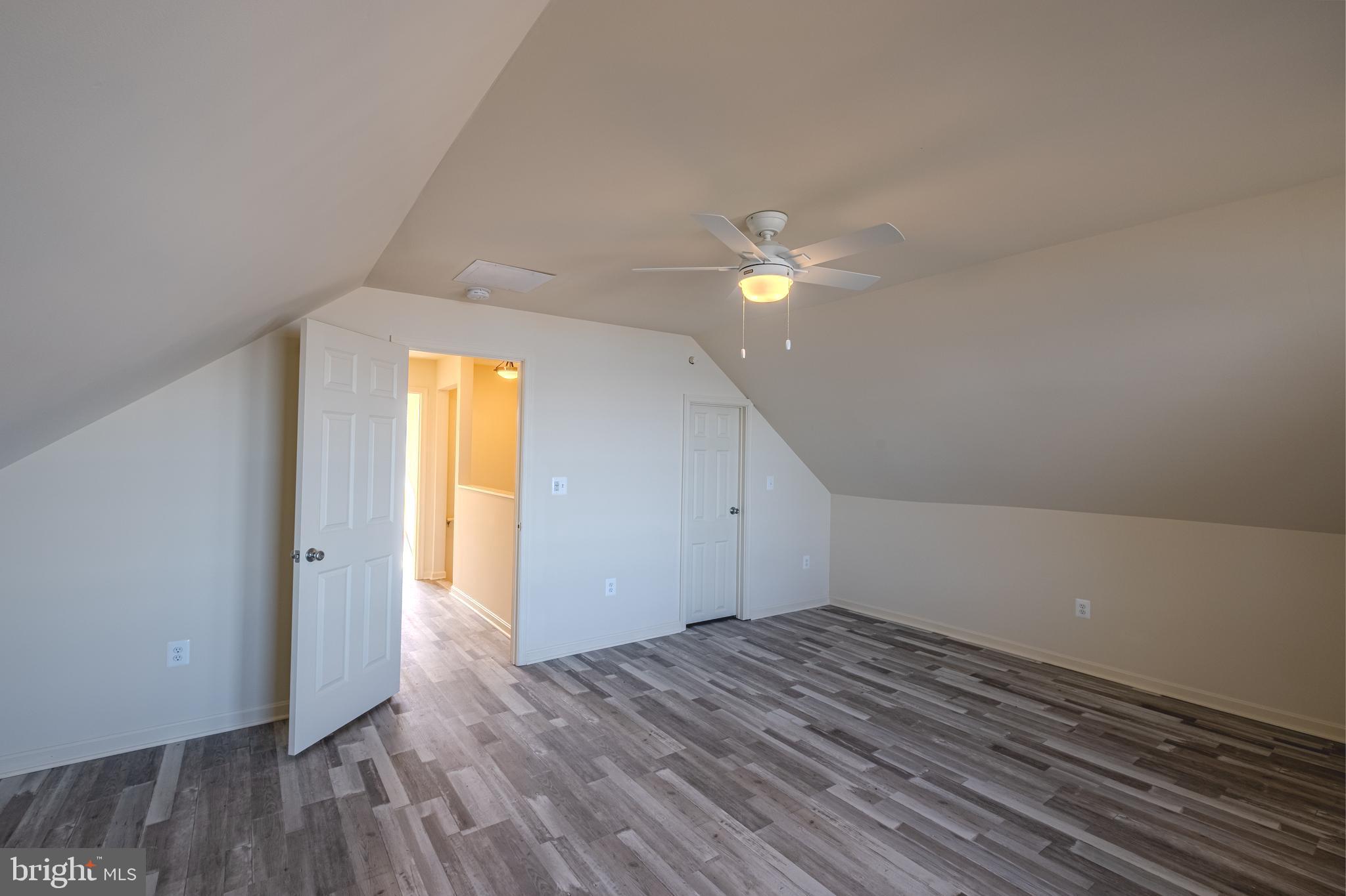 7391 Benedict Avenue Benedict, MD 20612 - Photo 23 of 38 a view of empty room with wooden floor and fan