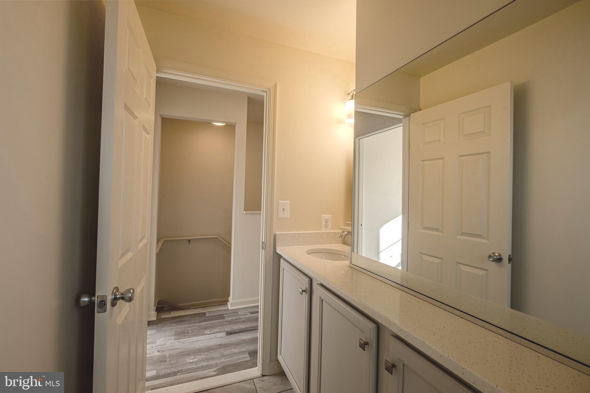 7391 Benedict Avenue Benedict, MD 20612 - Photo 30 of 38 a bathroom with a sink a mirror and a shower