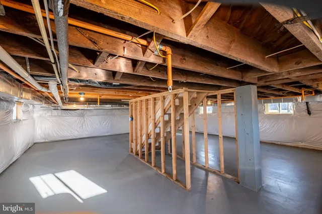 a view of water heater room with wooden floor
