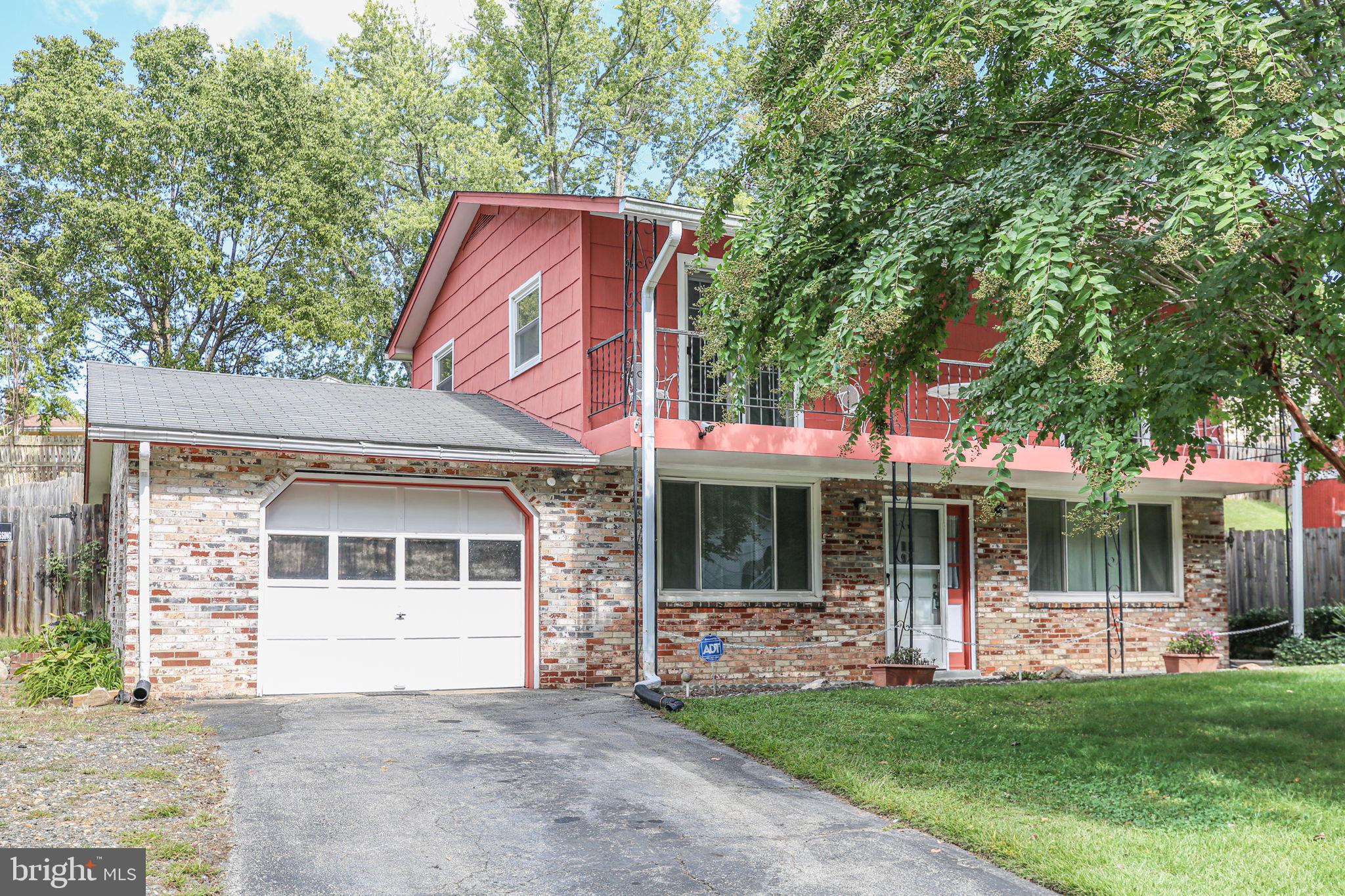 19007 Red Oak Lane Triangle, VA 22172 - Photo 2 of 34 a front view of a house with a garden