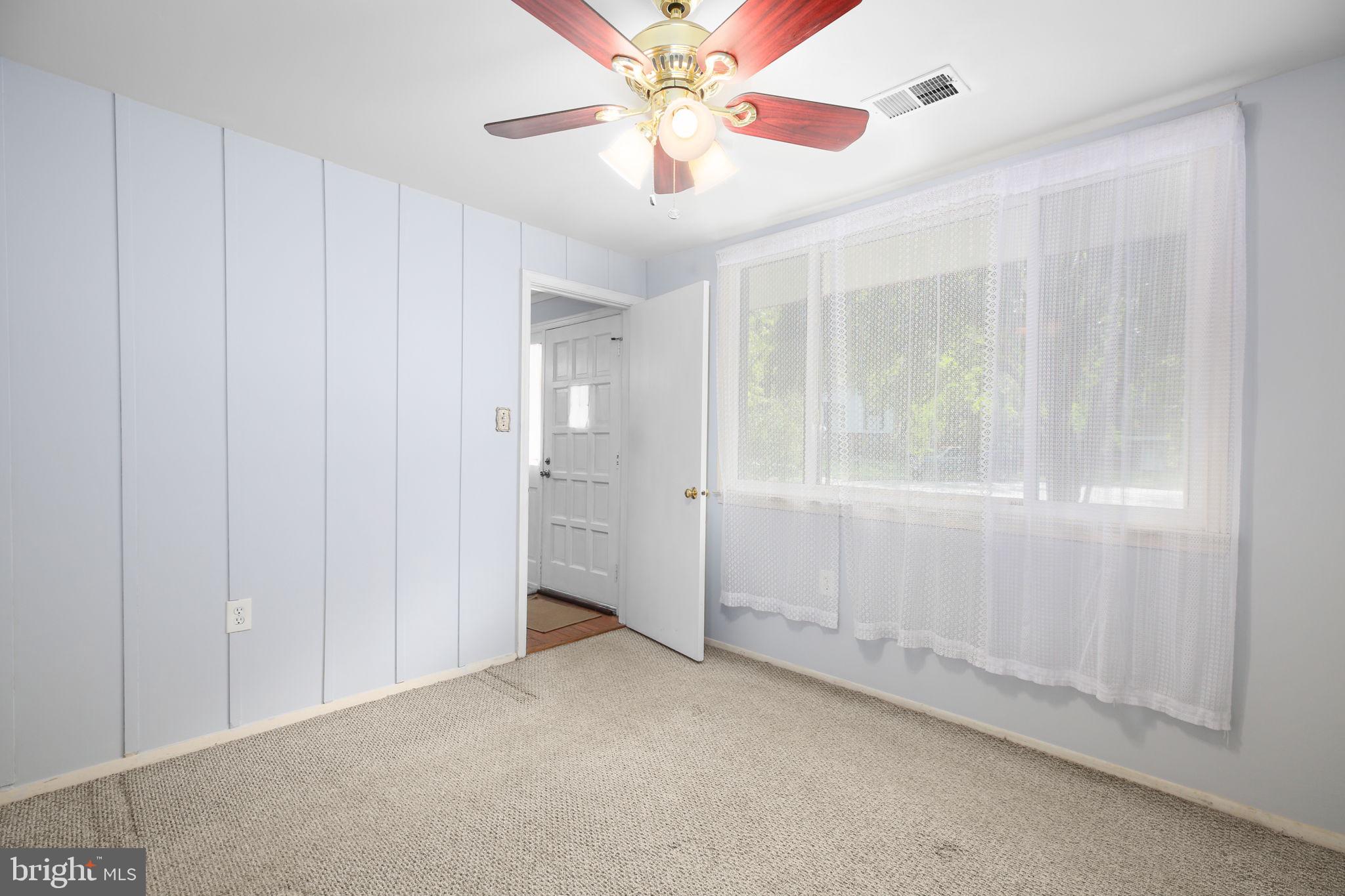 19007 Red Oak Lane Triangle, VA 22172 - Photo 23 of 34 a view of an empty room and window with a chandelier fan