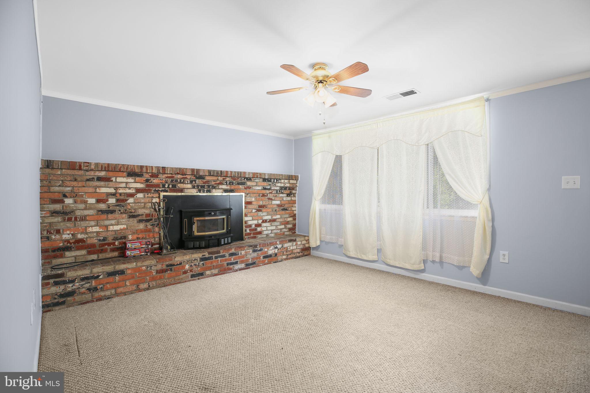 19007 Red Oak Lane Triangle, VA 22172 - Photo 3 of 34 an empty room with windows and fireplace