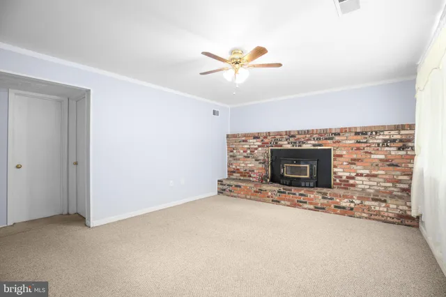 a view of an empty room with a fireplace