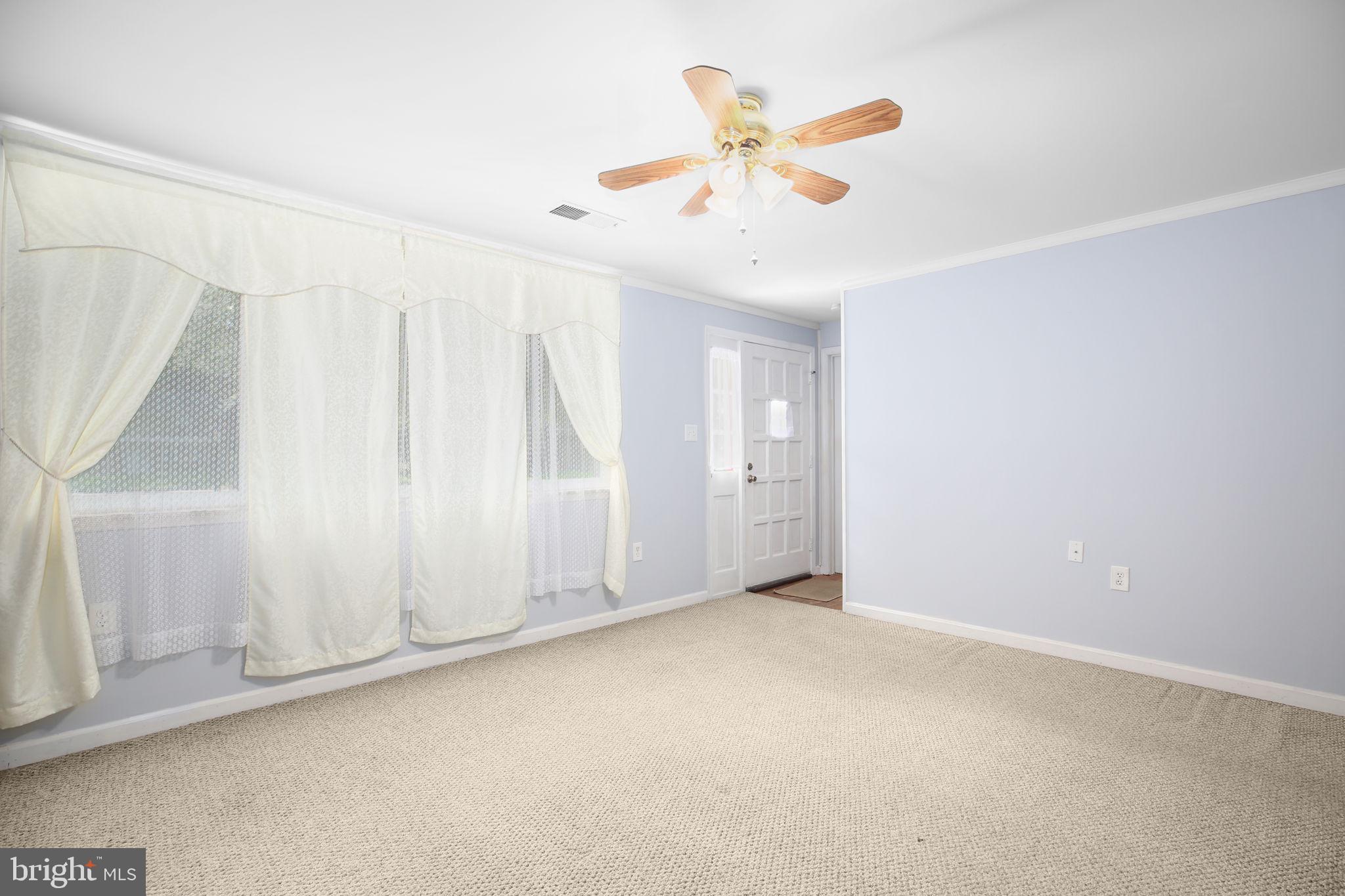 19007 Red Oak Lane Triangle, VA 22172 - Photo 5 of 34 an empty room with a window and ceiling fan