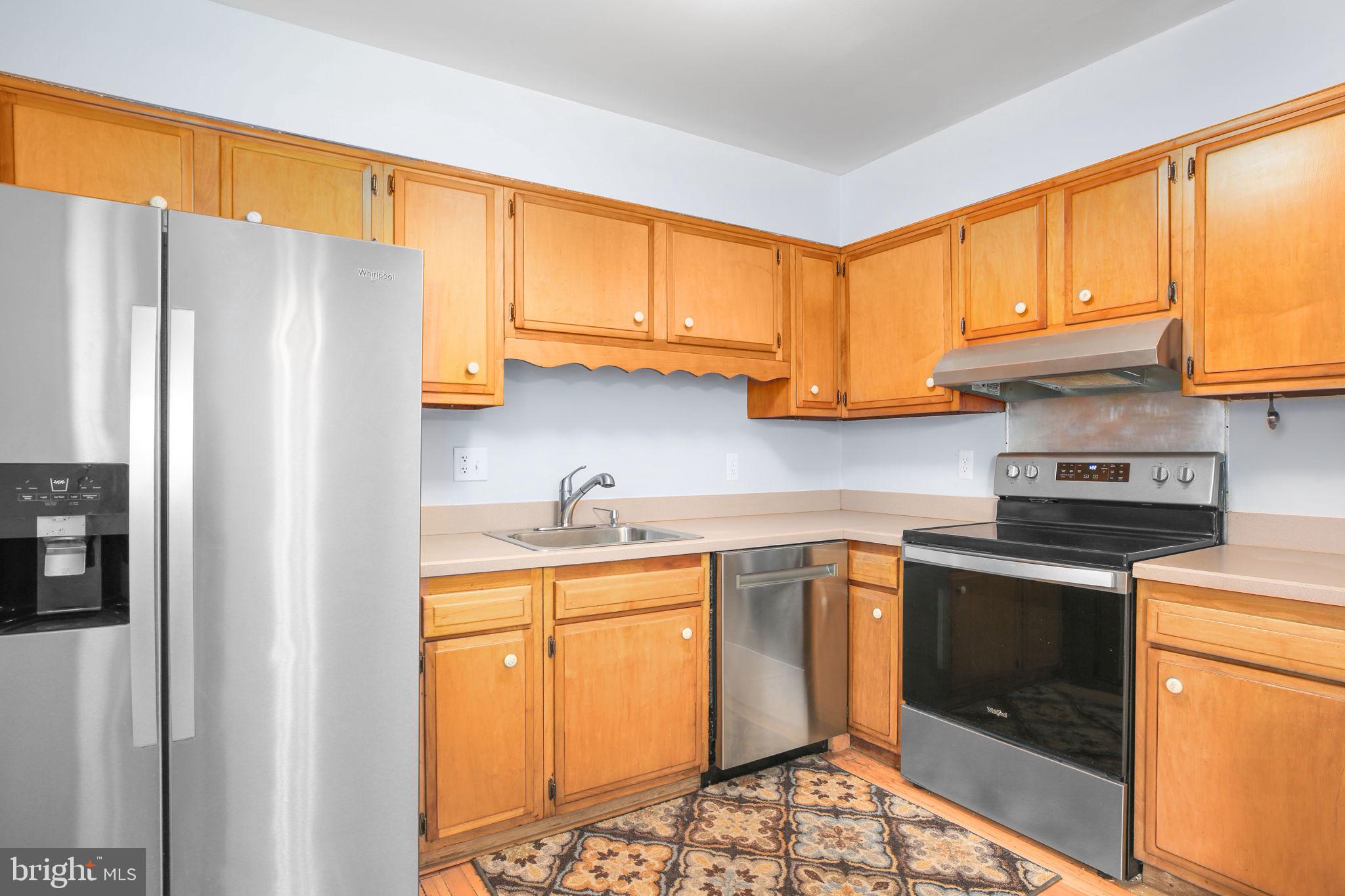 19007 Red Oak Lane Triangle, VA 22172 - Photo 10 of 34 a kitchen with stainless steel appliances granite countertop a refrigerator sink and cabinets