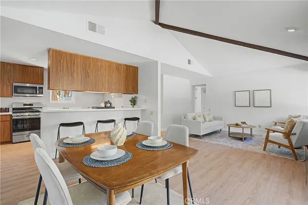 a view of a dining room with furniture and wooden floor