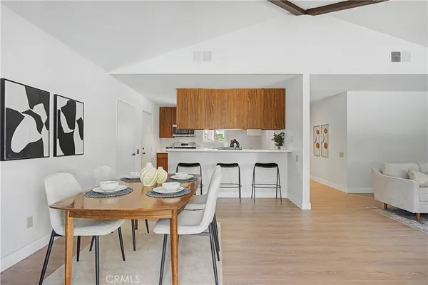 a kitchen with stainless steel appliances a stove microwave and sink