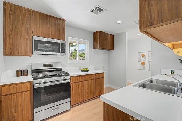 a kitchen with a sink stove and cabinets