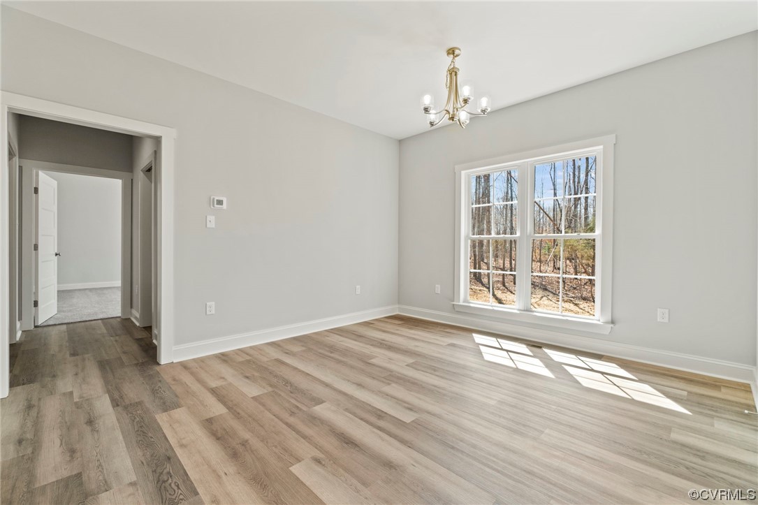3267 Paynes Mill Road Bumpass, VA 23024 - Photo 13 of 33 a view of an empty room with wooden floor and a window