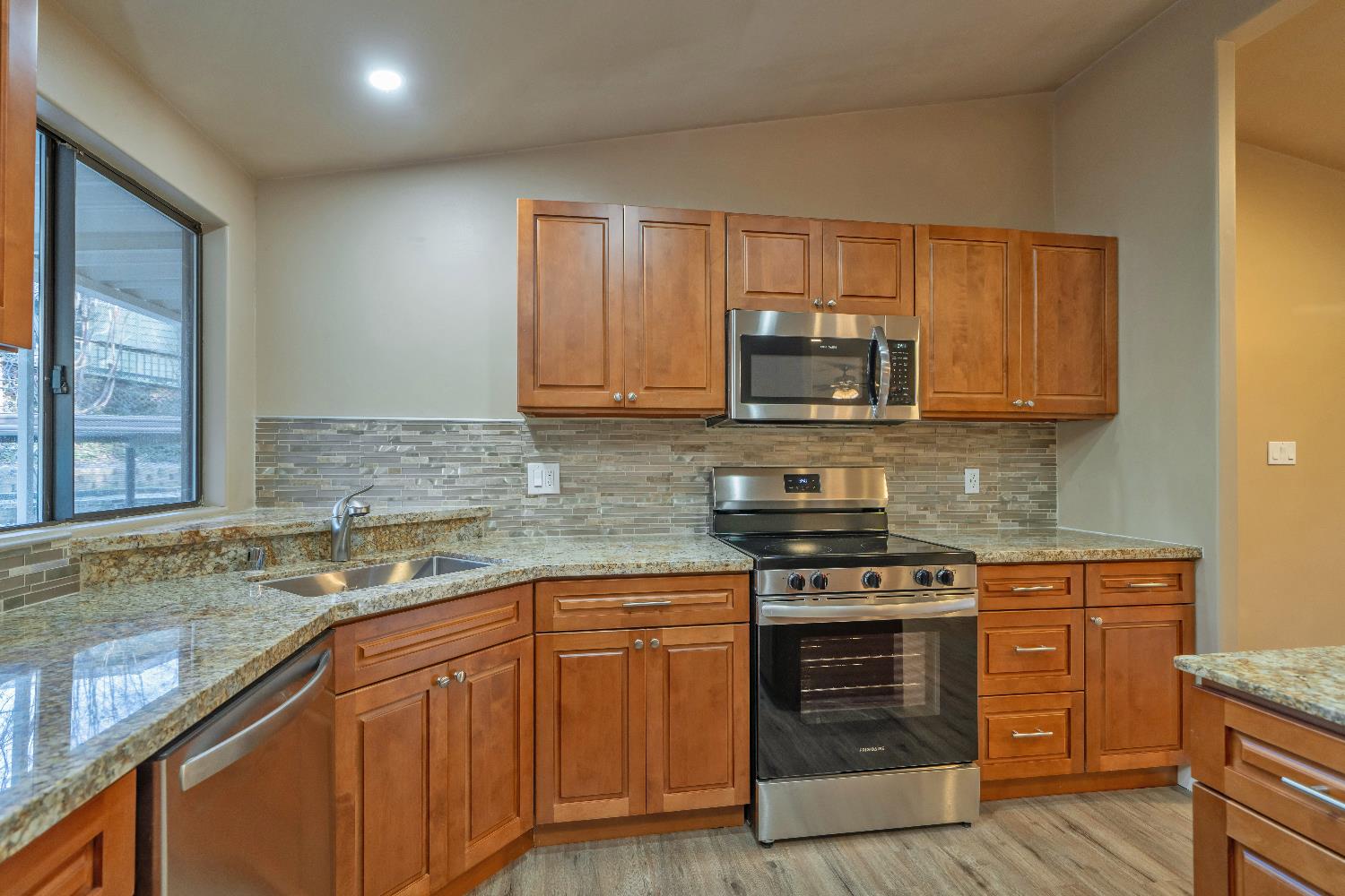 4420 Pleasant Valley Road, Unit 155 Diamond Springs, CA 95619 - Photo 14 of 42 a kitchen with stainless steel appliances granite countertop wooden cabinets stove top oven and sink