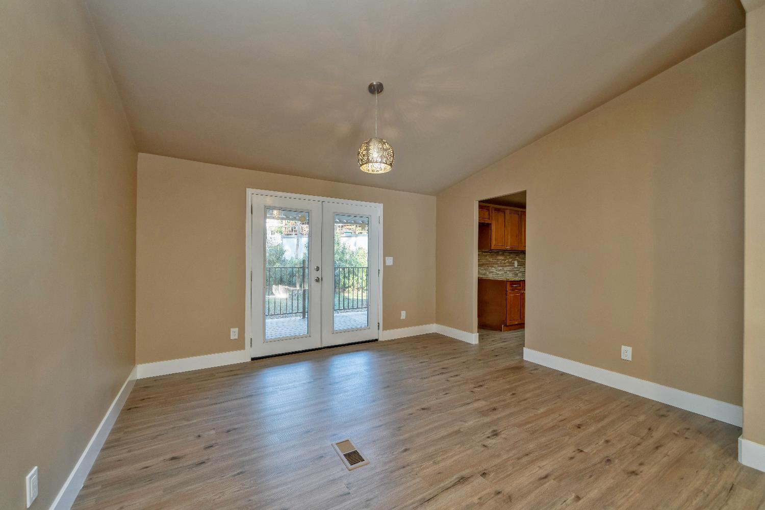 4420 Pleasant Valley Road, Unit 155 Diamond Springs, CA 95619 - Photo 21 of 42 a view of an empty room with wooden floor and a window