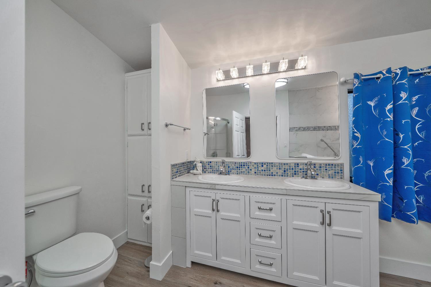 4420 Pleasant Valley Road, Unit 155 Diamond Springs, CA 95619 - Photo 26 of 42 a bathroom with a granite countertop toilet sink and mirror