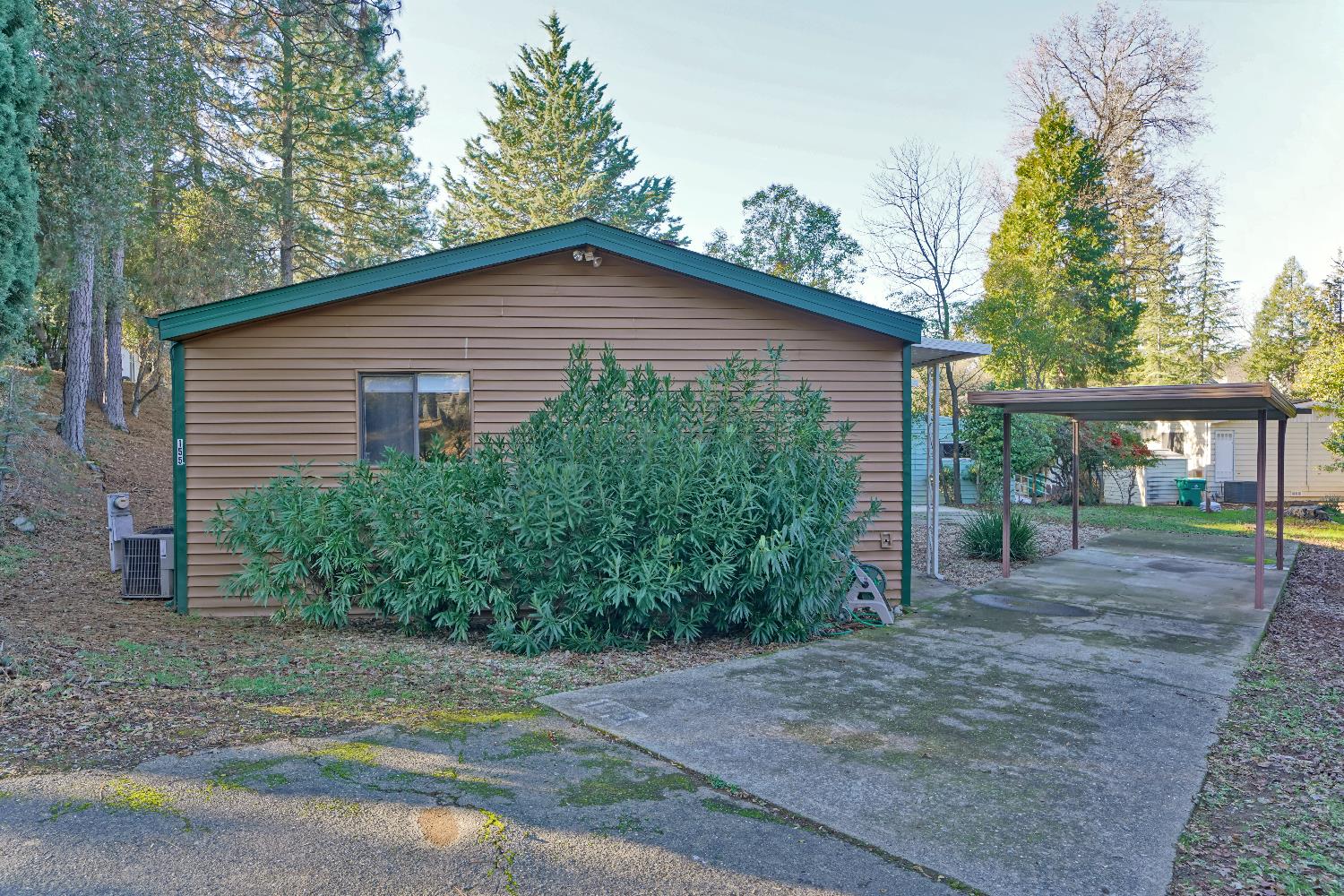 4420 Pleasant Valley Road, Unit 155 Diamond Springs, CA 95619 - Photo 36 of 42 a front view of a house with a yard and potted plants